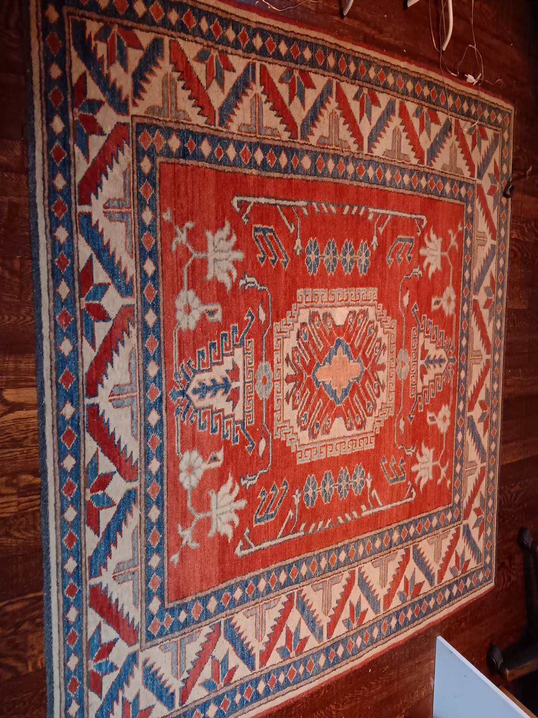 A red and blue rug
AI-generated content may be incorrect.
